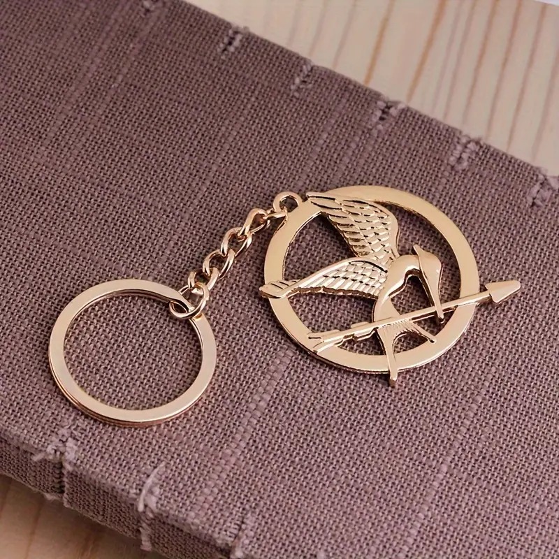 Klíčenka Hunger Games - Reprodrozd - zlatá